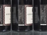 four bottles of wine are lined up on a table