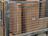 many boxes stacked on top of each other in a cage