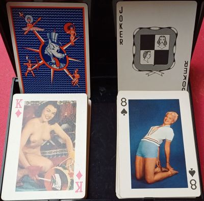 quatre cartes à jouer dans un étui noir posé sur une table