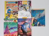 plusieurs livres pour enfants sont alignés sur une surface blanche