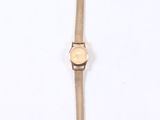 a close up of a wrist watch on a white surface