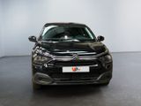 the front view of a black citrole parked in a room
