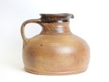 a brown vase with a brown handle on a white background