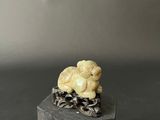 an elephant figurine sitting on top of a wooden block