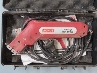 a red tool in a case with wires in it