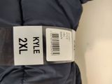 a label on the back of a jacket that says xxle