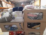 a carton full of clothes and other items in a warehouse