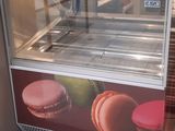 a display case with macarons on it in a store