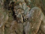 a statue of a man sitting on a rock