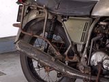 a old motorcycle that is parked in a garage