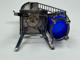 a blue glass bowl sitting on top of a metal stove