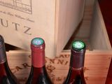 three bottles of wine sitting in a wooden box
