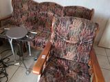 a couch and a chair in a room with tile flooring