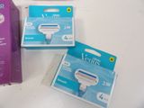 three boxes of razors sitting on a table next to each other