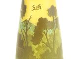a vase with a painting on it sitting on a table