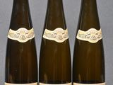 three bottles of wine sitting on top of a table next to each other