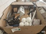 une boîte en carton remplie d'objets hétéroclites sur le sol