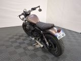 a motorcycle that is parked on a checkered floor