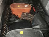 several pieces of luggage are sitting in a basket in the back of a car