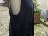 a dress on a mannequin stand on a cobblestone street