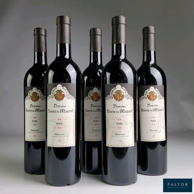 quatre bouteilles de vin sont alignées sur une table