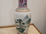 a vase that is sitting on a table with a picture on it
