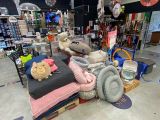 a pile of stuffed animals sitting on a bed in a store