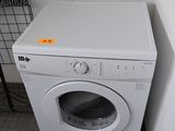 a white washer and dryer in a small room