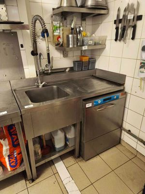 a kitchen with a sink and a dishwasher in it