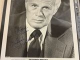 an old photo of a man in a suit and tie with a pen