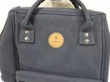 a blue backpack with a brown label on it