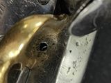 someone is using a pair of scissors to cut a piece of metal