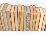 a lot of old books stacked on top of each other