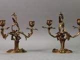 pair of antique brass candelabs with flowers on each of them