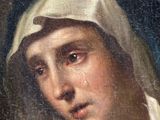 an oil painting of a woman with a veil on her head