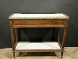 a small wooden table with a marble top on a wooden floor