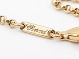 a close up of a gold bracelet with a name engraved on it