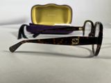 a pair of glasses sitting on a table next to a case