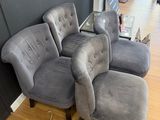 a grey couch and chair in a room with wood floors
