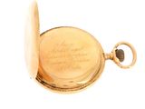 an old gold pocket watch with a chain on a white background