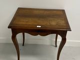 a small wooden table with a small drawer on it