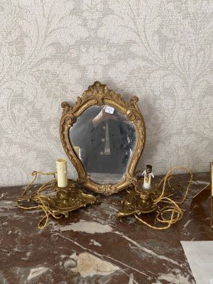a table with a mirror and a candle on it