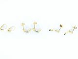 three pairs of gold earrings on a white background
