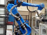 a blue robot that is standing in a building