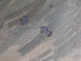 two small holes in the concrete of a building