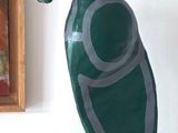 a statue of a turtle on a shelf next to a painting