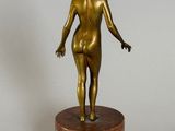 bronze statue of a woman standing on a marble base