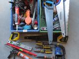 many different tools in a box on the floor