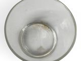 a glass bowl with a small amount of water in it