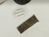 a close up of a metal plate with a stamp on it